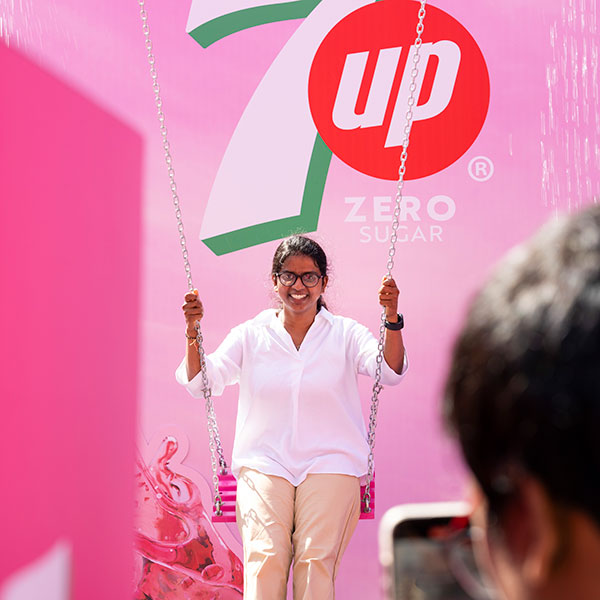 Consumer enjoying the 7UP Pink waterfall swing