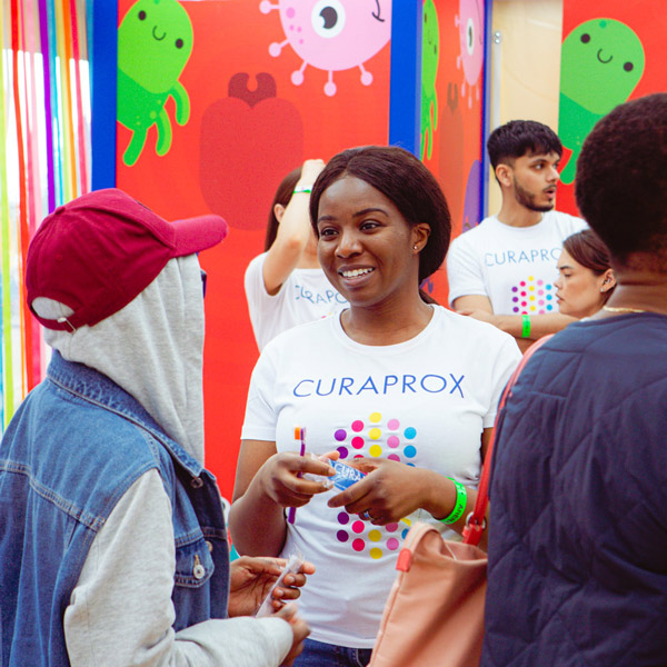 Young woman smiling at Curaprox event